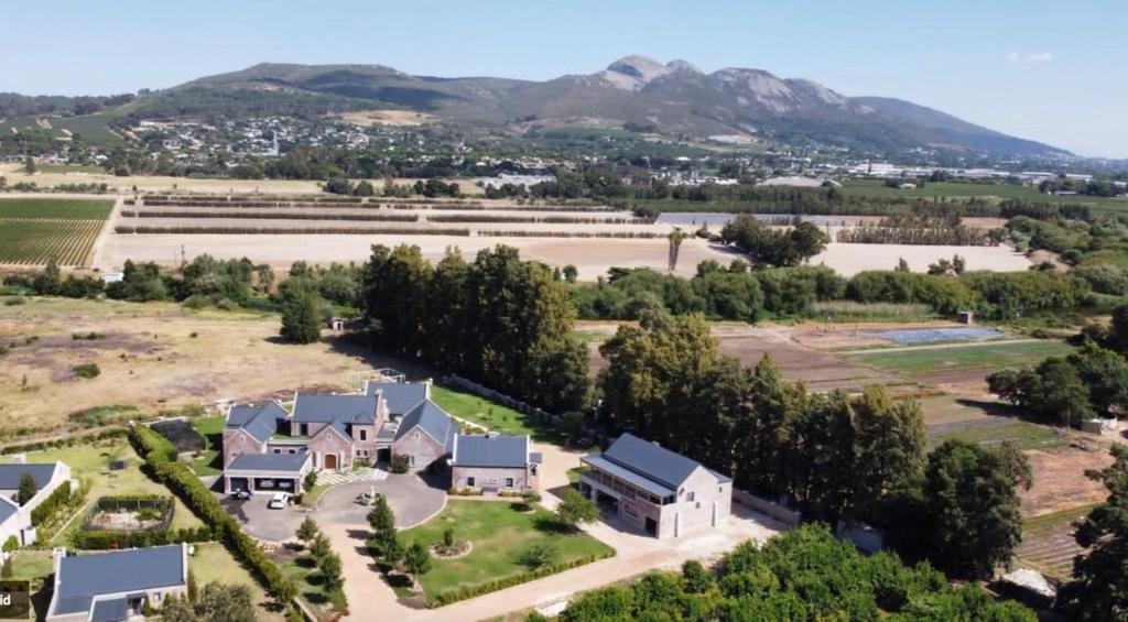 an aerial view of a large estate with mountains in the background at 2-Bedroom apartment - Riverside bliss in Paarl in Paarl
