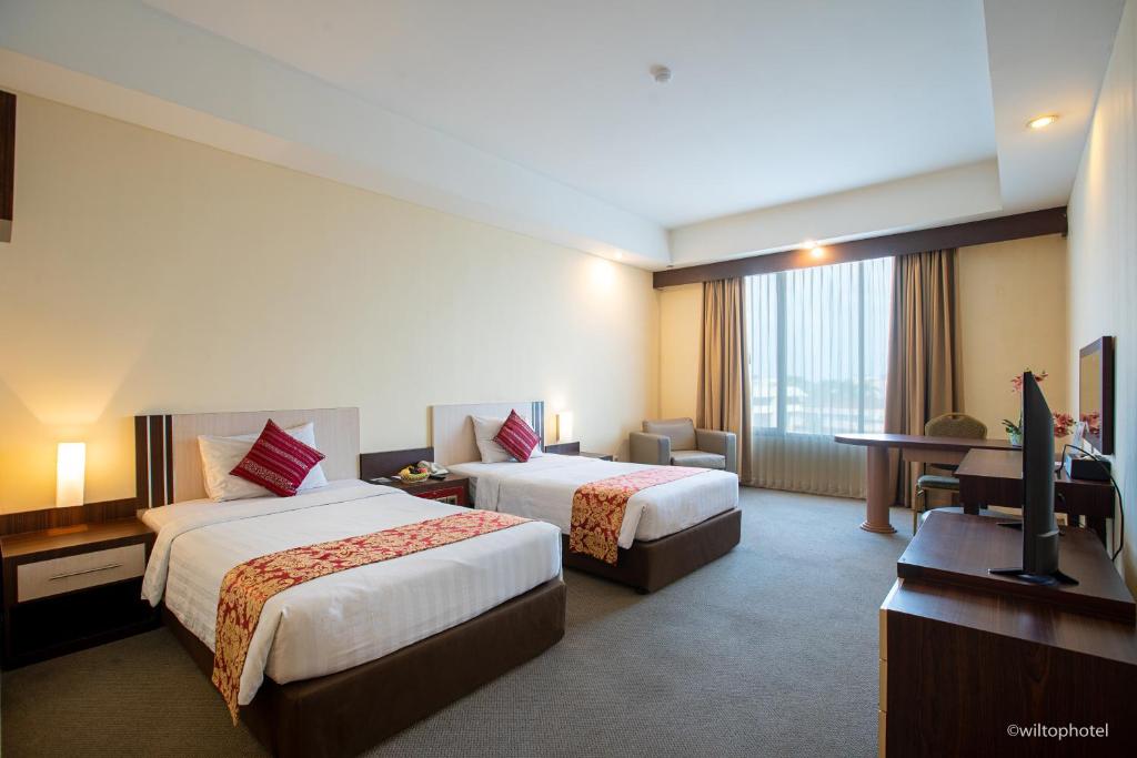 Postel nebo postele na pokoji v ubytování Wiltop Hotel Jambi