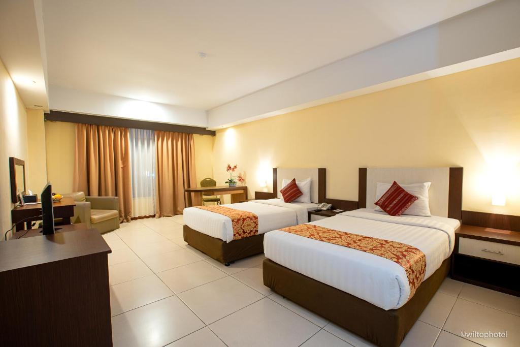 Postel nebo postele na pokoji v ubytování Wiltop Hotel Jambi