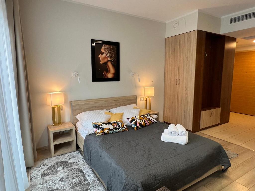 ein Schlafzimmer mit einem Bett mit zwei Handtüchern darauf in der Unterkunft I&M Apartments Krawiecka Wrocław in Breslau