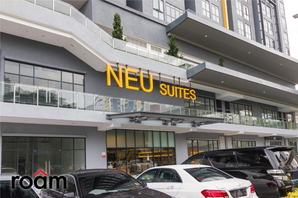 a new suites building with cars parked in front of it at Neu Suites Residence Kuala Lumpur, Roam in Kuala Lumpur
