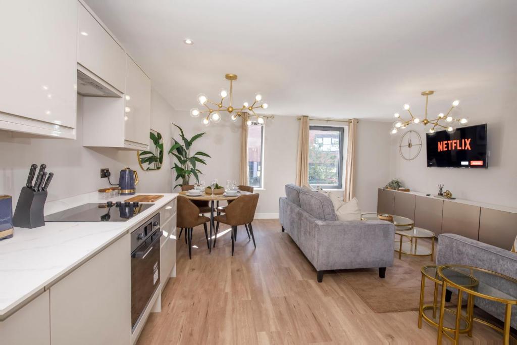 a kitchen and living room with a table and chairs at Crescent Court modern and luxurious Apartments York in York