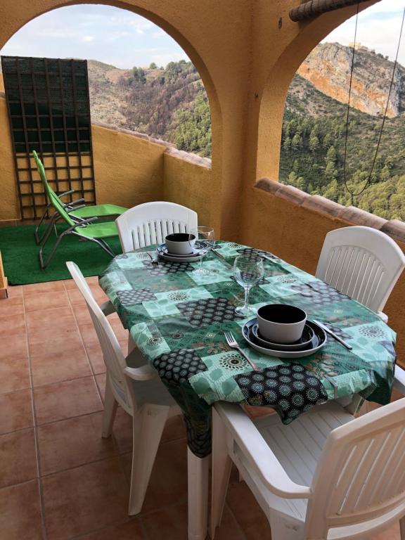 a table with white chairs and a table cloth on it at Paraíso in Cumbre del Sol