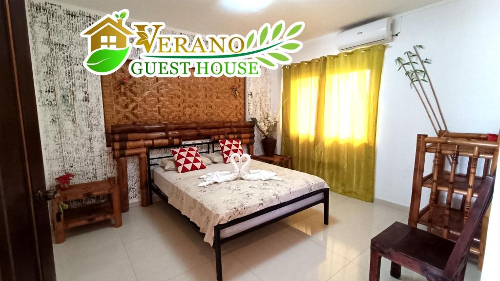 a room with a guest house sign on the wall at Verano GuestHouse in Tagbilaran City