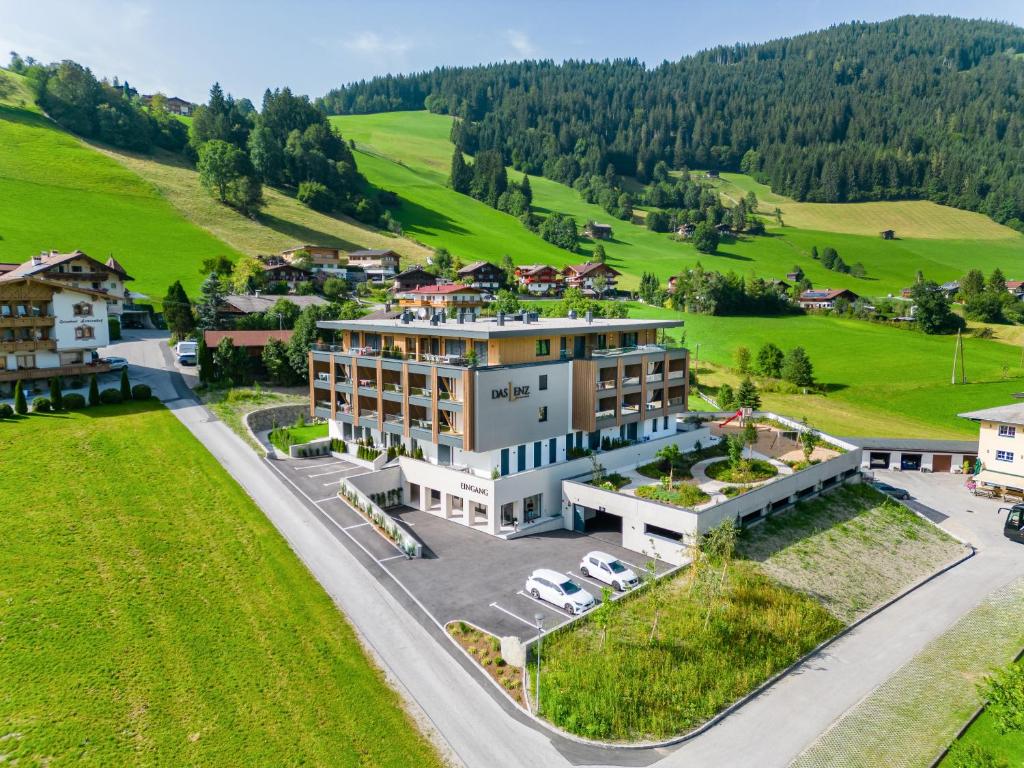 an aerial view of a building in a green field at Das Lenz by Inncomer in Oberau