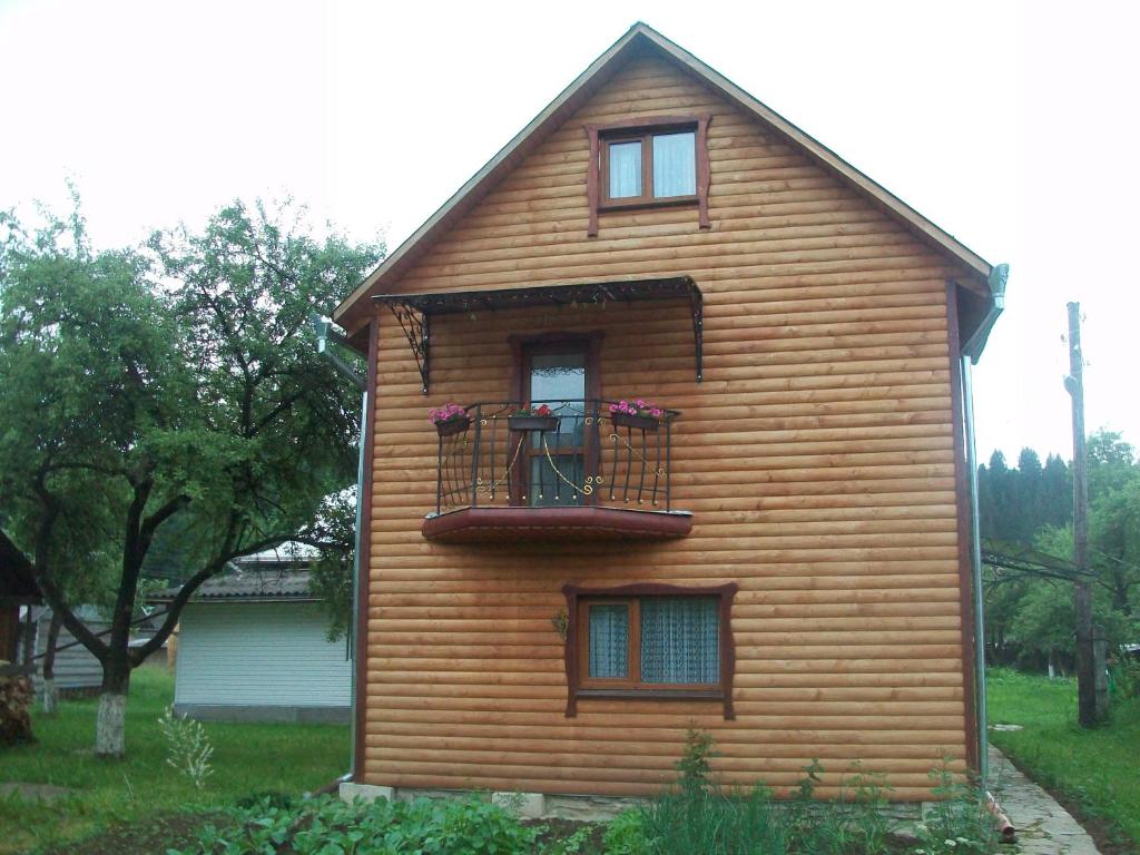 a house with a balcony on the side of it at Pidkova in Verkhovyna