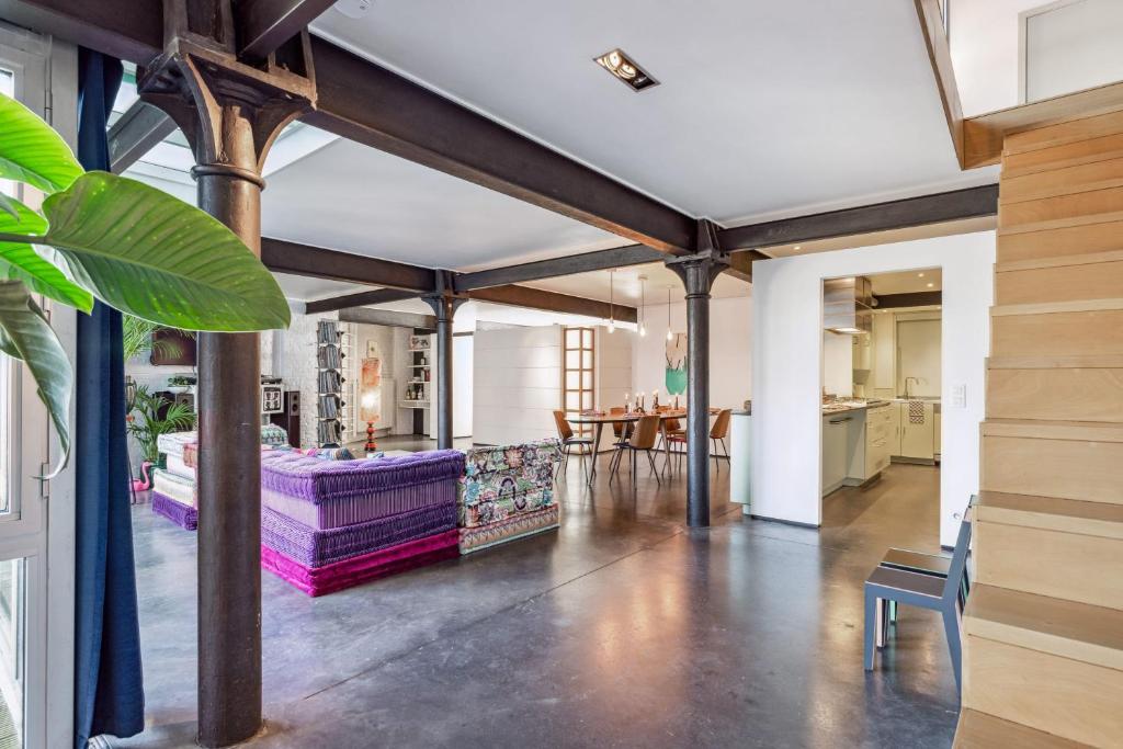 a living room with a couch and a table at Industrial loft near the center of Ghent in Ghent