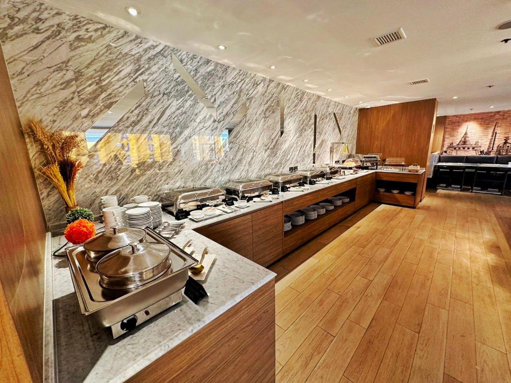 A breakfast buffet line with covered hot dishes and serving counters.