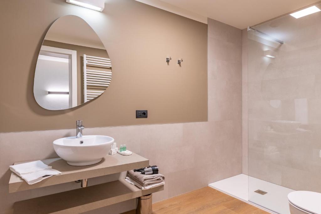 a bathroom with a sink and a mirror at The Place - Only Self Check-in - No Reception in Trento