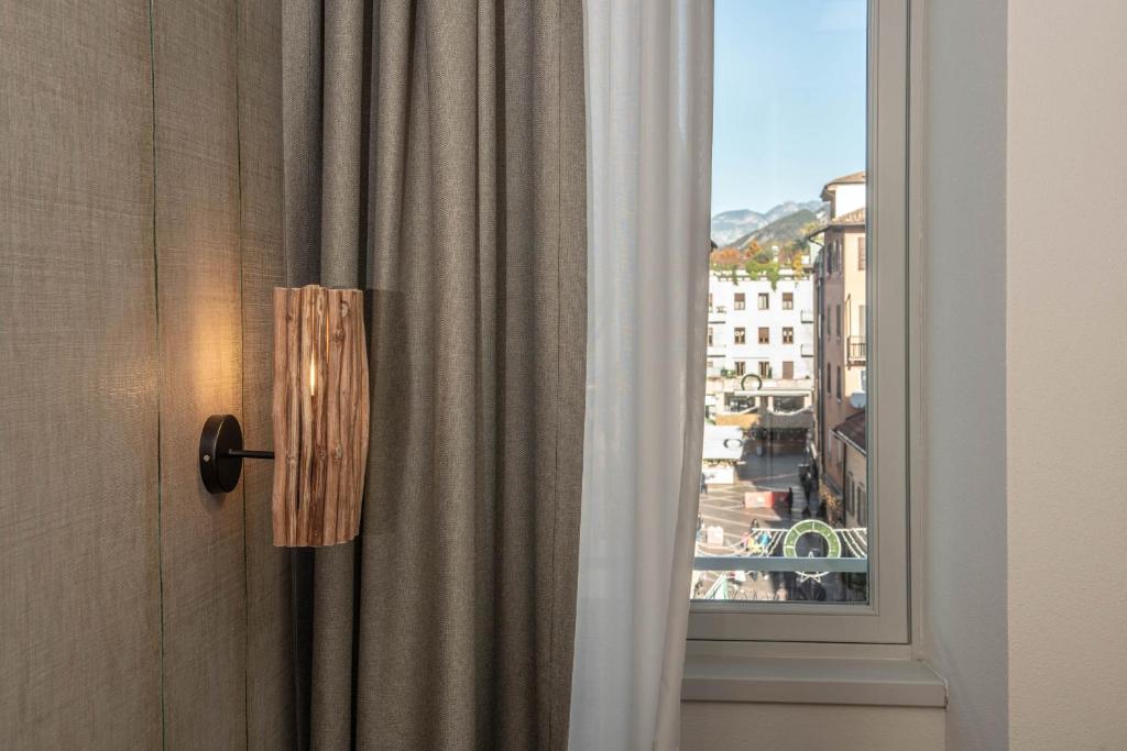a door with a window with a view of a city at The Place - Only Self Check-in - No Reception in Trento