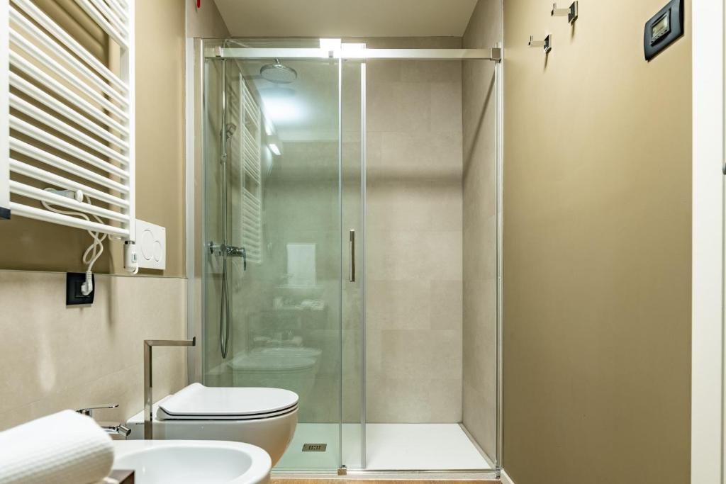 a bathroom with a shower and a toilet and a sink at The Place - Only Self Check-in - No Reception in Trento