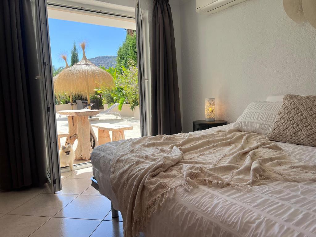 a bedroom with a bed and a view of a patio at Boutique Casa Lapicida in Calpe
