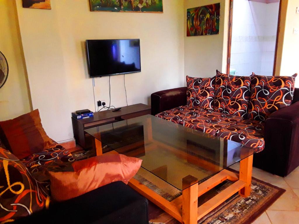 a living room with a couch and a coffee table at New Kitisuru D in Nairobi