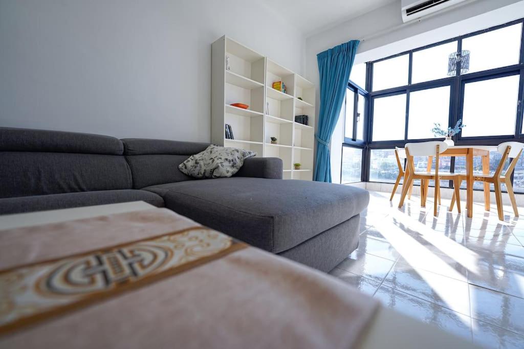 a living room with a couch and a table at Salina. Peaceful 2 bedroom flat in Naxxar