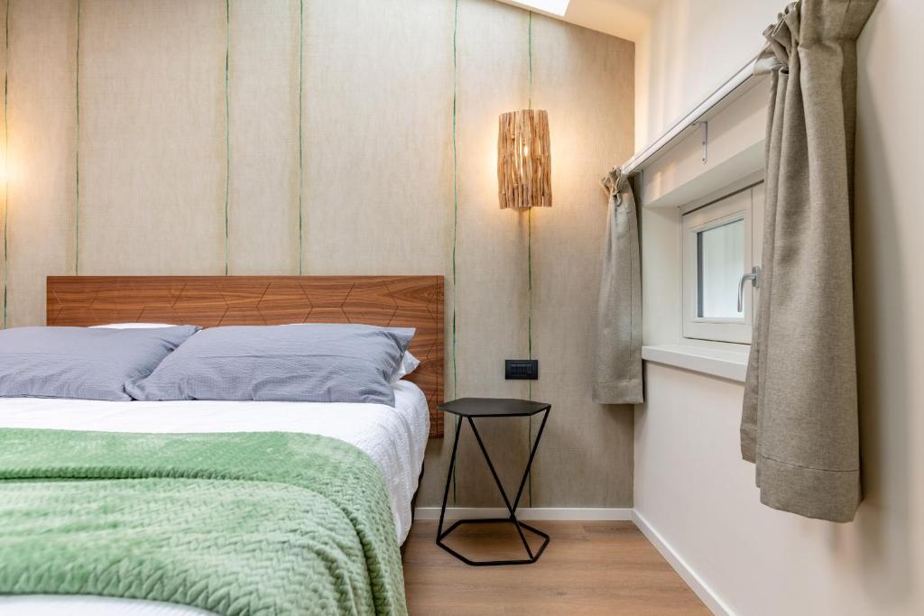 a small bedroom with a bed and a window at The Place - Only Self Check-in - No Reception in Trento