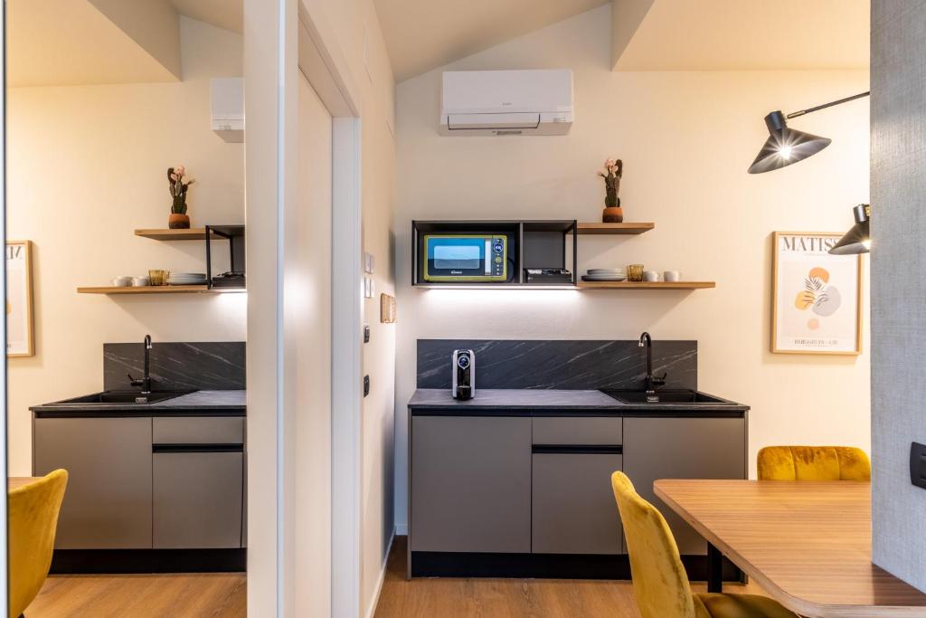 a kitchen with two counters and a table at The Place - Only Self Check-in - No Reception in Trento