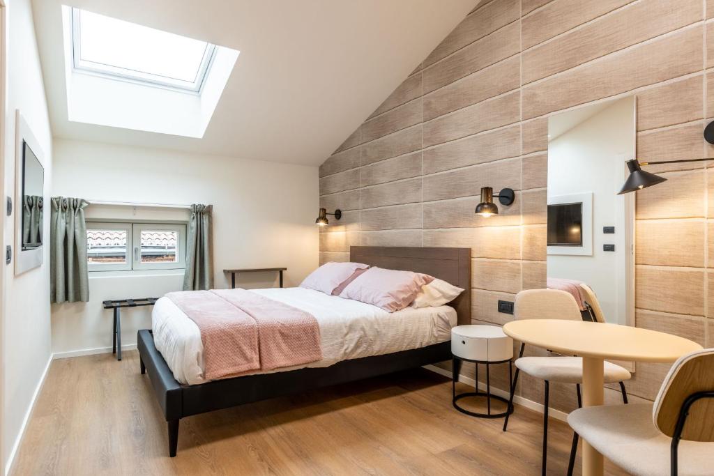 a bedroom with a bed and a table at The Place - Only Self Check-in - No Reception in Trento