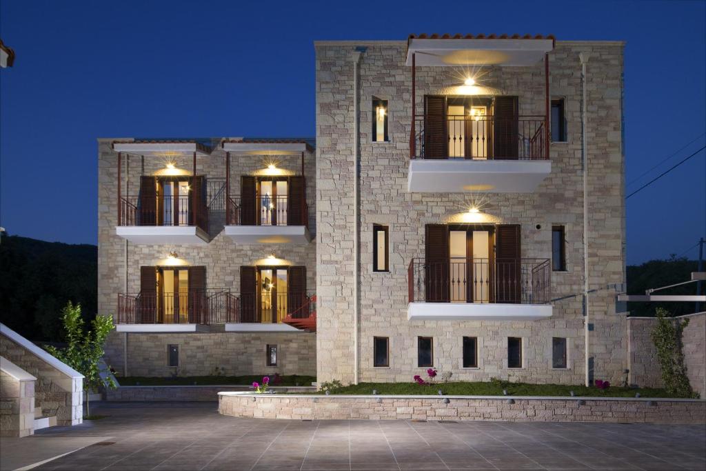 a large brick building with lights on it at Aelia Sivota in Syvota