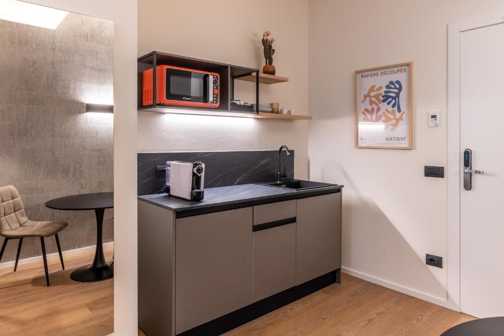 a kitchen with a counter top with a microwave at The Place - Only Self Check-in - No Reception in Trento