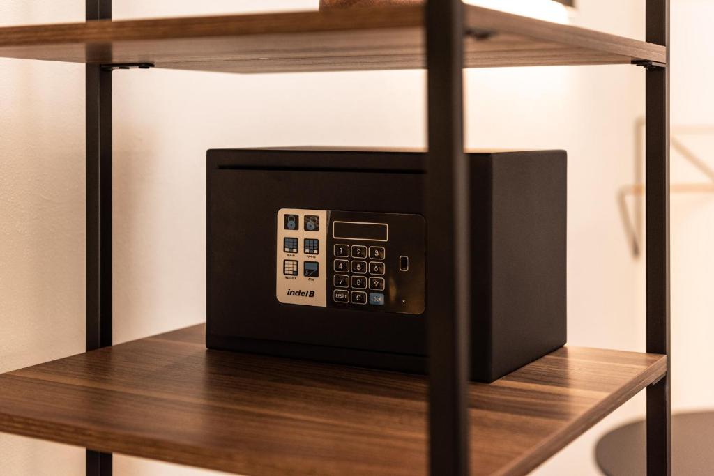 a microwave sitting on top of a wooden shelf at The Place - Only Self Check-in - No Reception in Trento