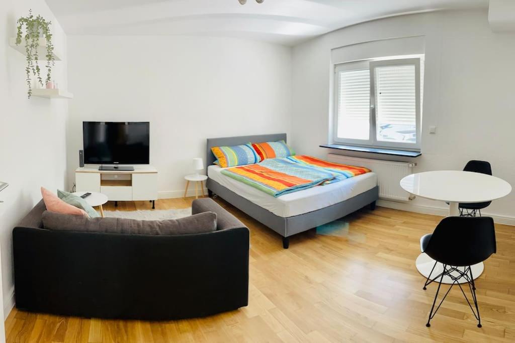 1 dormitorio con cama, sofá y mesa en Gemütliches 1-Zimmer Appartement, en Langen