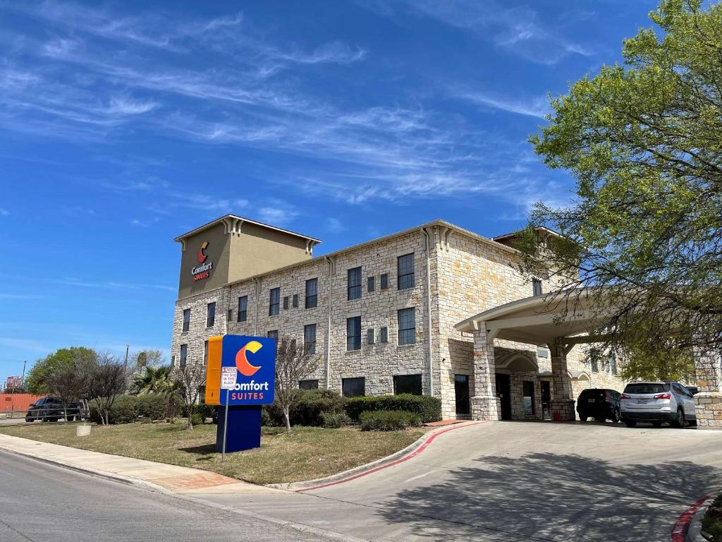 a building with a sign in front of it at Comfort Suites Near Seaworld in San Antonio