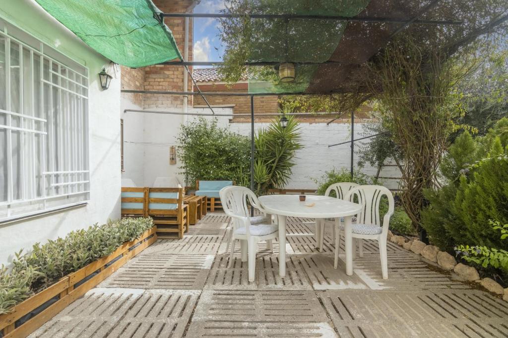 d'une terrasse avec une table et des chaises blanches. dans l'établissement Cal Marcos, à Torregrosa