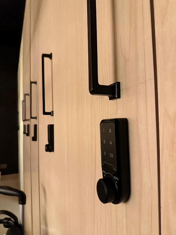a close up of a wooden door with a latch at WeStay Budget Hostel in Dubai