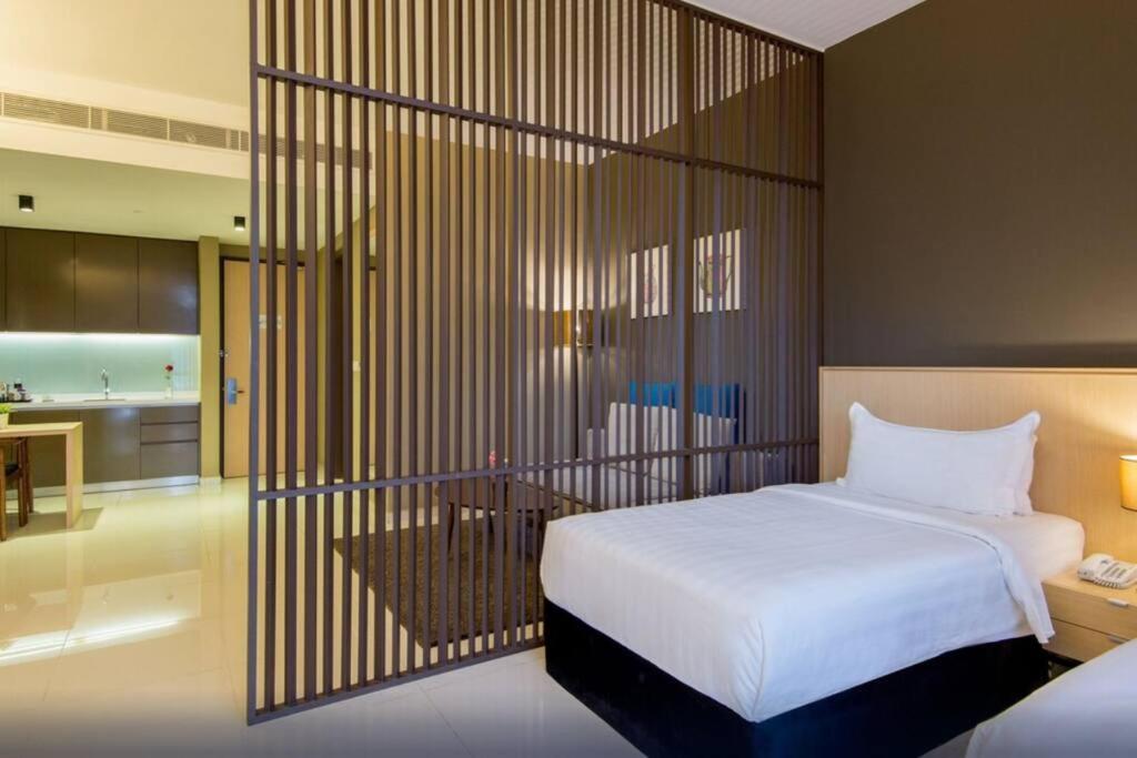 a hotel room with a bed and a kitchen at D' Pines -Family Suite in Malacca