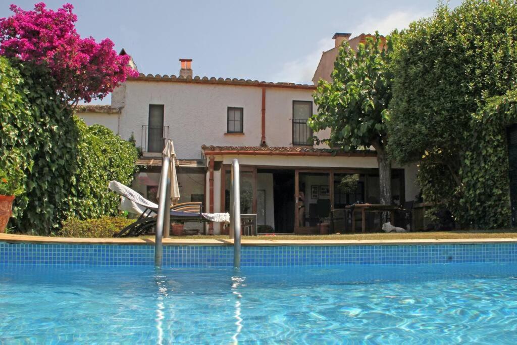 a swimming pool in front of a house at Casa acogedora en Begur in Begur