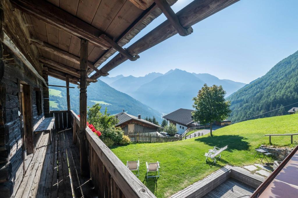 a balcony of a house with a view of mountains at Mountain Chalet Obertreyen in Campo Tures