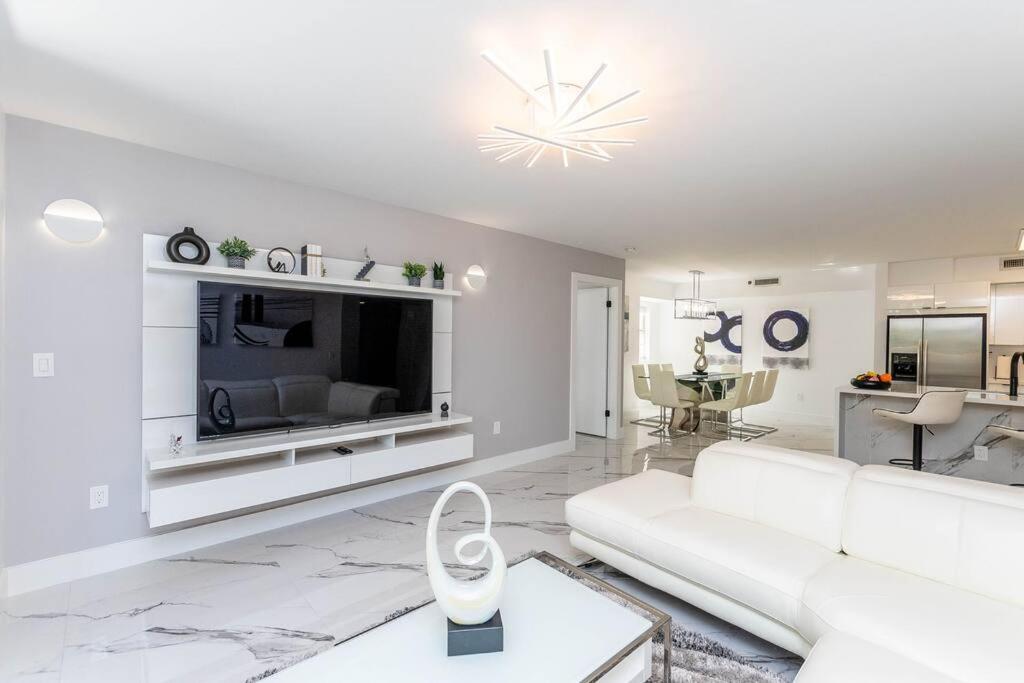 a white living room with a white couch and a tv at Luxury VIP 3 Bed 2 Bath Apartment Yacht Club Aventura in Miami