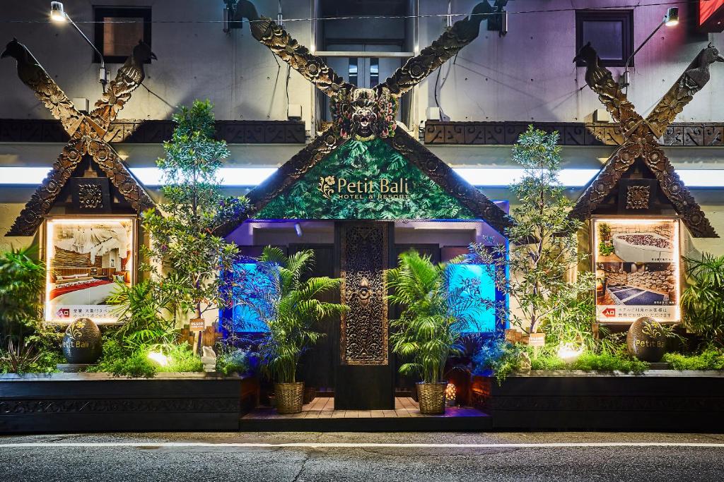 a store front with a christmas display with plants at Petit Bali Ikebukuro in Tokyo