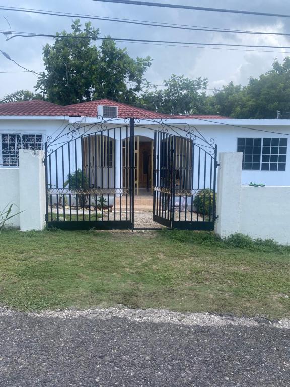 a house with a gate in front of it at 3-Bed House in Montego Bay 10 min from airport in Montego Bay