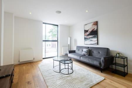 a living room with a couch and a table at Stylish East London Flat MS2 in London