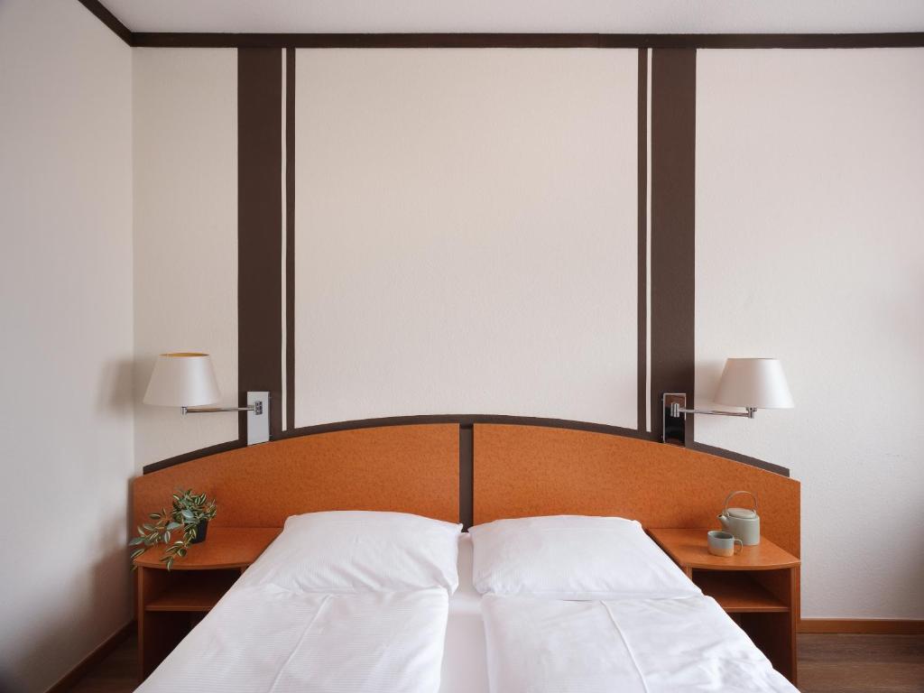 Postel nebo postele na pokoji v ubytování Mühlenhotel Halle-Leipzig