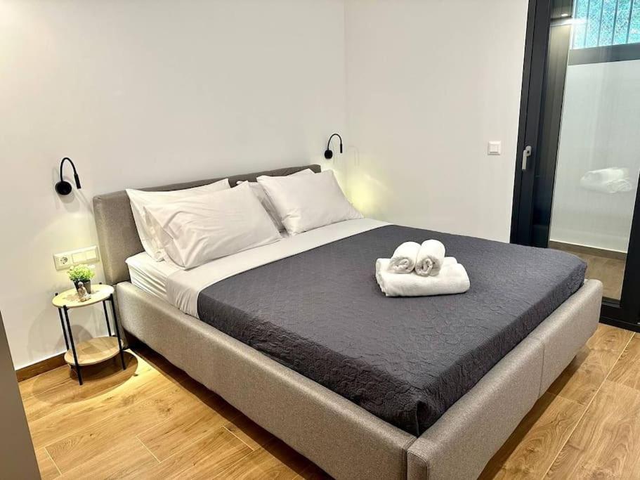a bedroom with a bed with two towels on it at Relax Home in Moschato 2 vipgreece in Piraeus