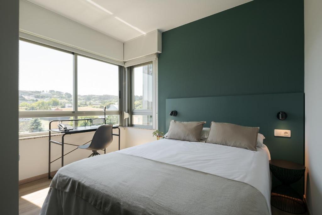 Posteľ alebo postele v izbe v ubytovaní Someso Apartamentos Turisticos
