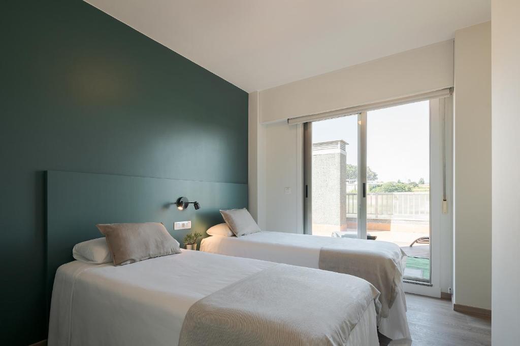 Posteľ alebo postele v izbe v ubytovaní Someso Apartamentos Turisticos