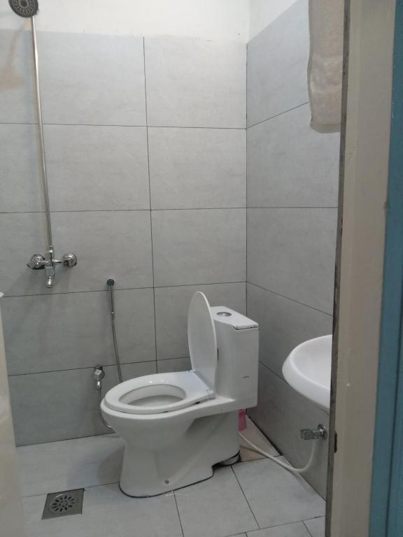 a bathroom with a toilet and a sink at Apartment first floor for rent near commercial market satellite town Rawalpindi in Rawalpindi
