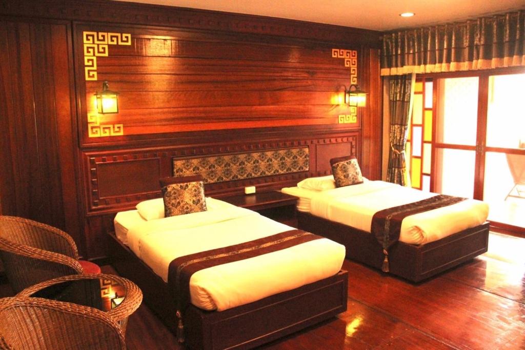 Postel nebo postele na pokoji v ubytování ดอยหมอกดอกไม้รีสอร์ท DoiMok DokMai Resort