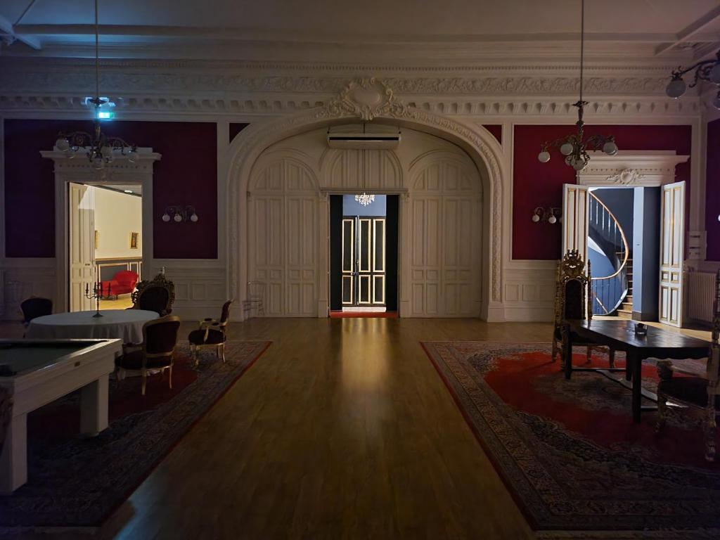 a large room with a table and a pool table at Salon Boyer in Épernay