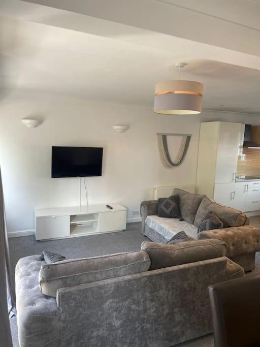 a living room with two couches and a flat screen tv at Whole Apartment Near to London in Bromley