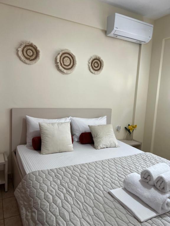 a bedroom with a large bed with towels on it at Stergios_Apartments 02 in Kozani