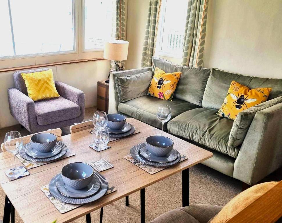 a living room with a couch and a coffee table at Eden Breaks, Mallard Lake in Cirencester