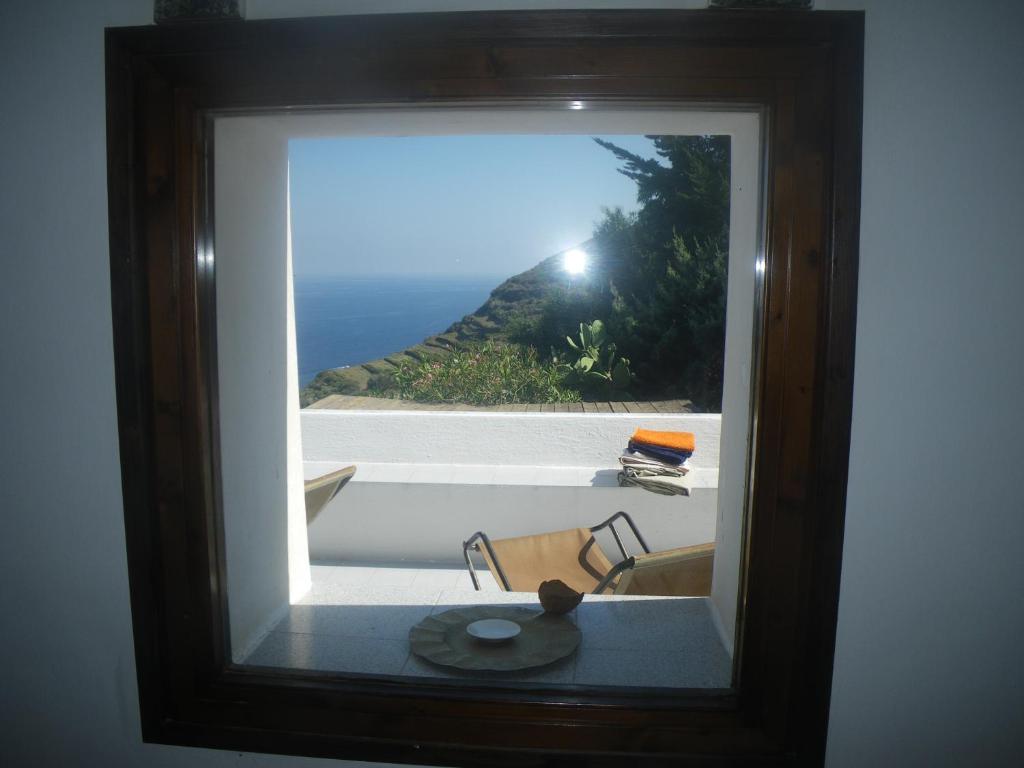 a picture of a window with a view of the ocean at sull'arco dell'elefante in Pantelleria