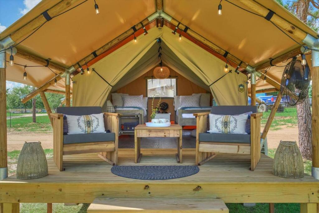 a gazebo with chairs and a table at BeeWeaver Luxury Glamping - All That Glitters in Navasota