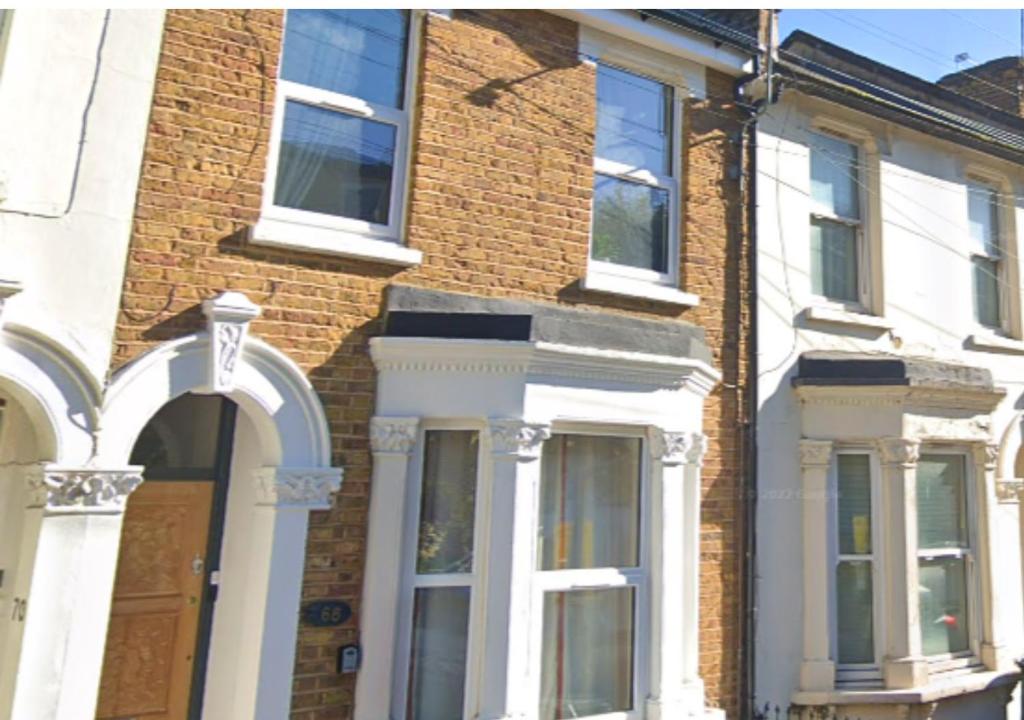 a brick house with white doors and windows at Modern 2 Bedroom Apartment in Peckham London in London