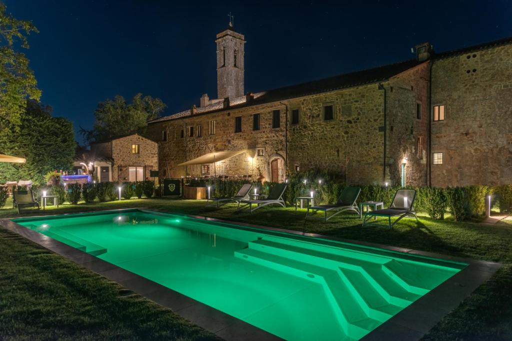 uma piscina em frente a um edifício à noite em Convento San Bartolomeo em Abbadia San Salvatore