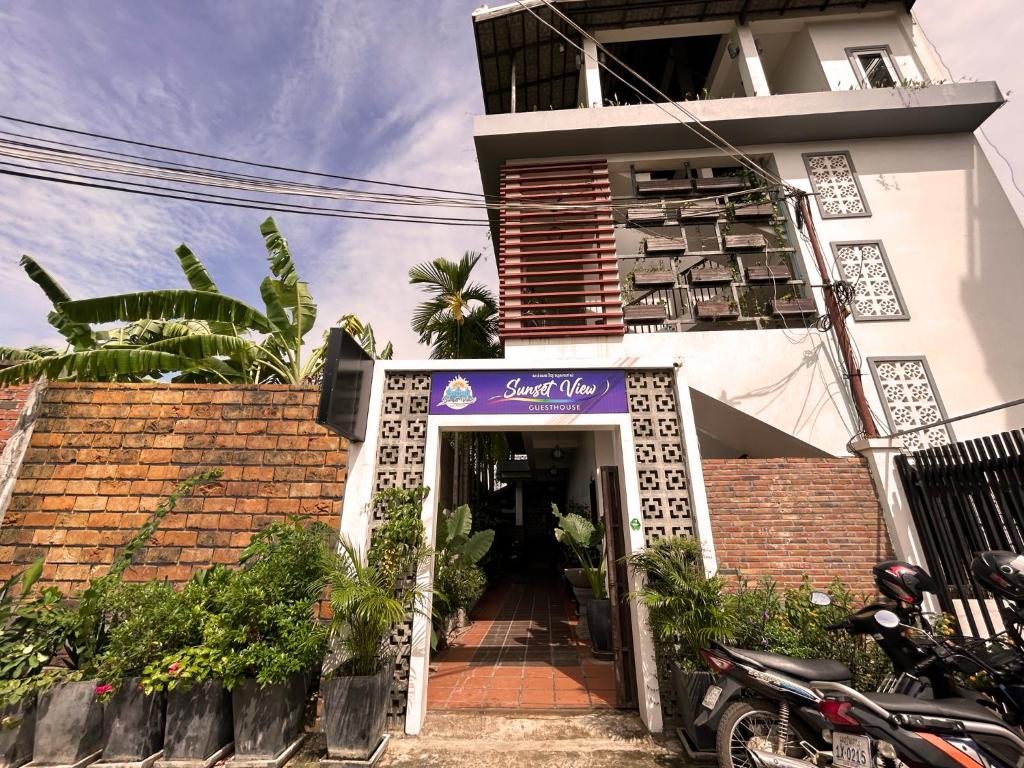 a building with a purple sign in front of it at Sunset View Guest House in Siem Reap